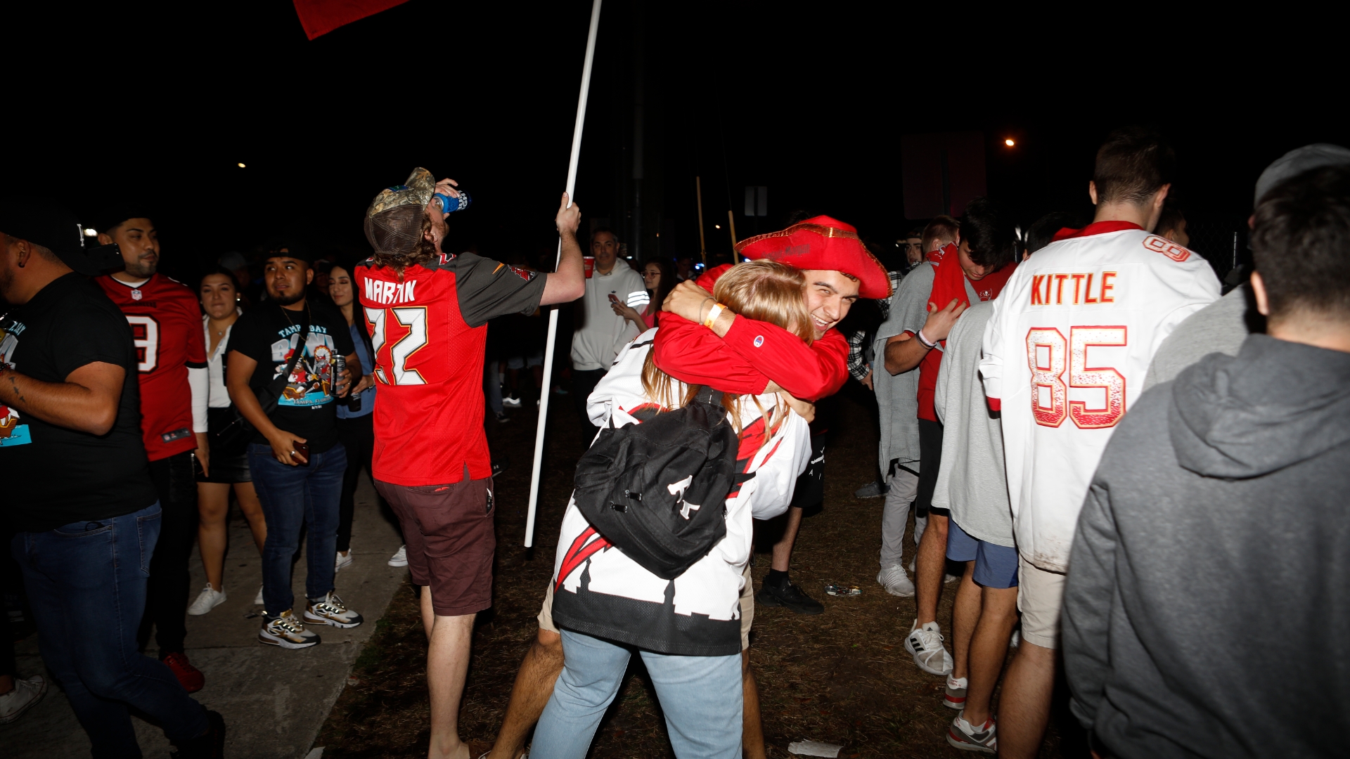 Maskless fans celebrate the Super Bowl in Tampa's streets. - The