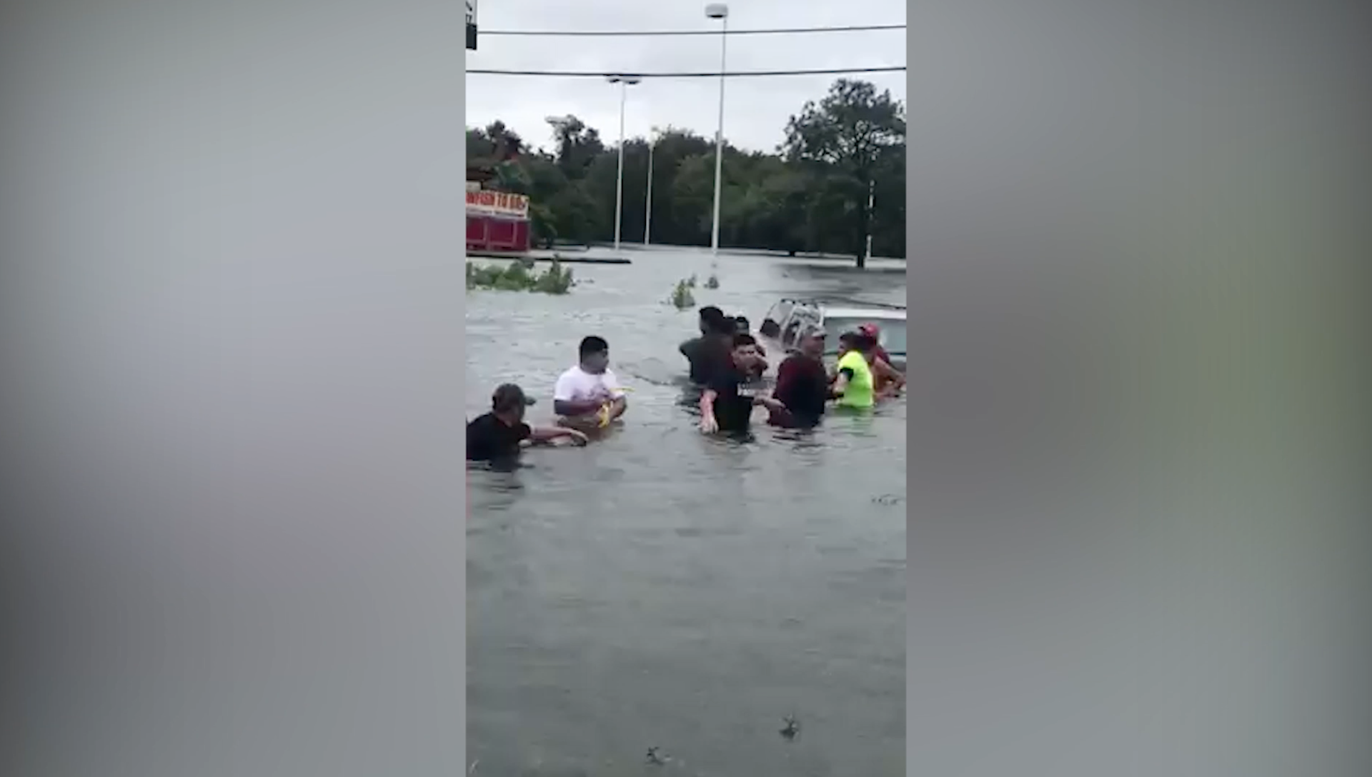 Body camera shows water rescue of woman trapped by flood